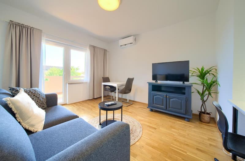 Living room with balcony access, small apartment